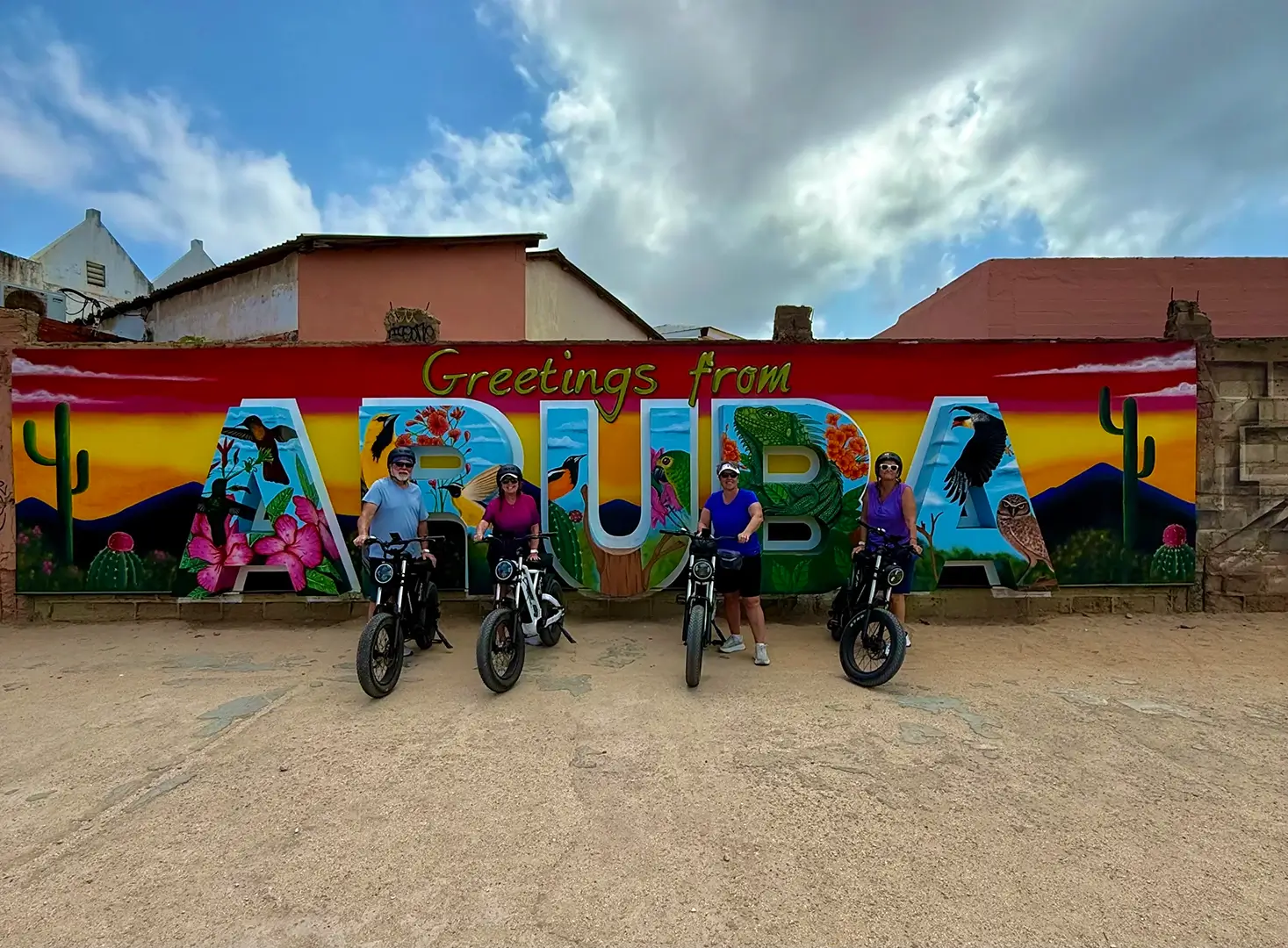 Group at the Greetings from Aruba mural in San Nicolas