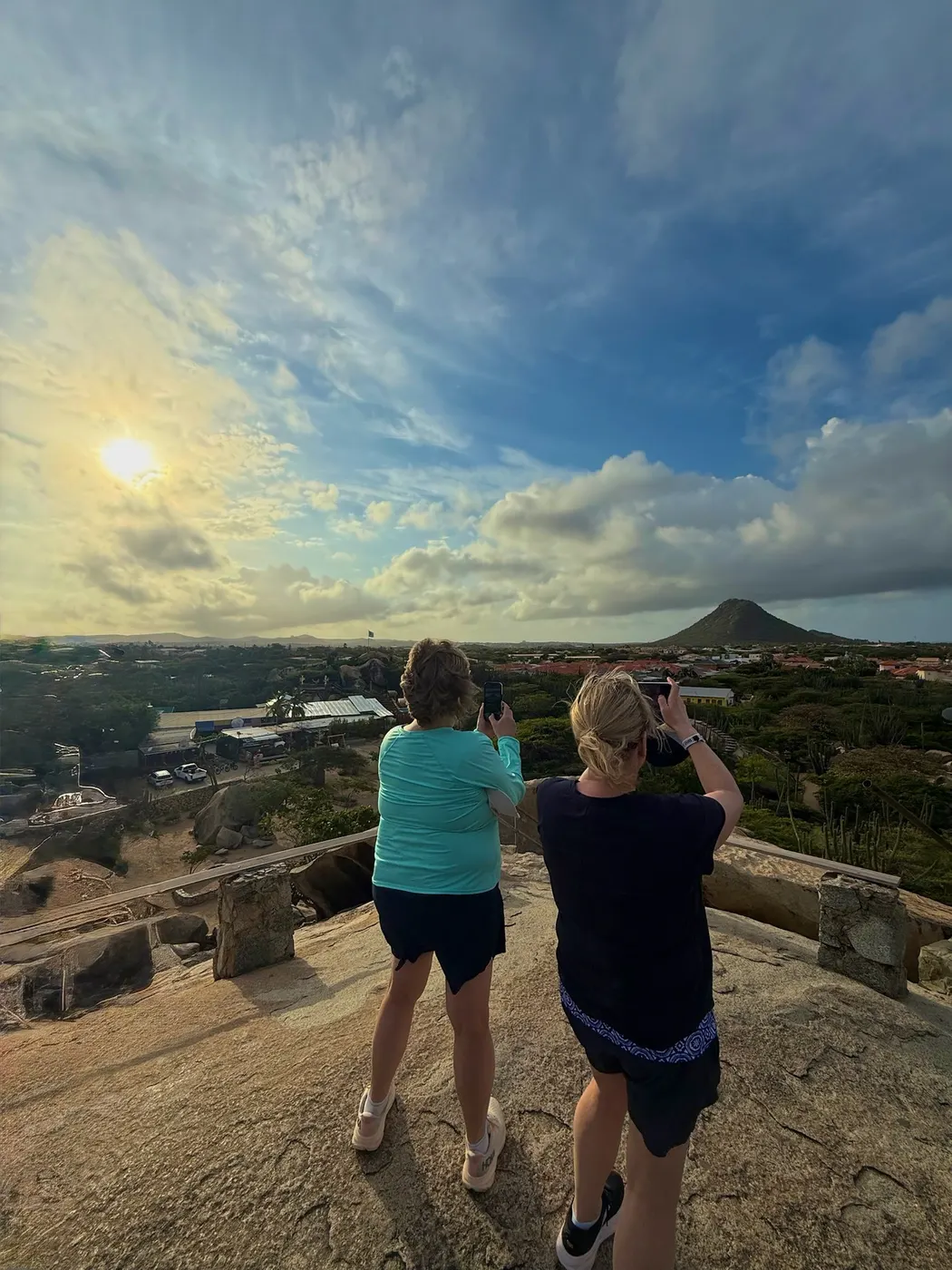 Guests taking photos of the sunrise from a scenic overlook