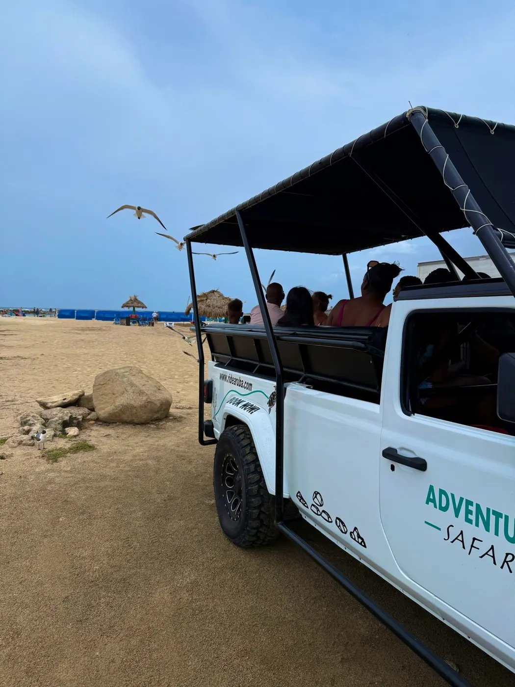 Adventure Safari jeep with guests at the beach